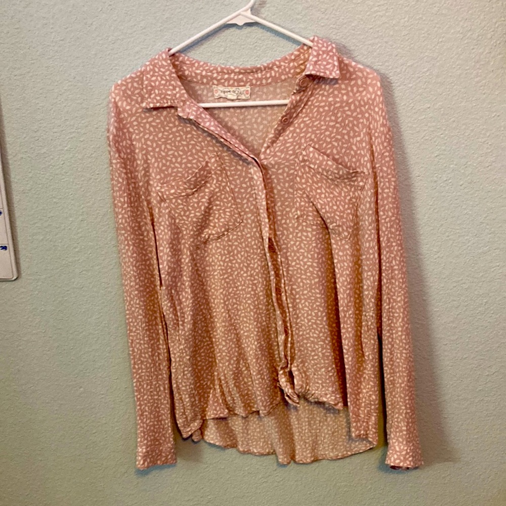 A large, long sleve, pink and white hippie rose button up T-shirt.